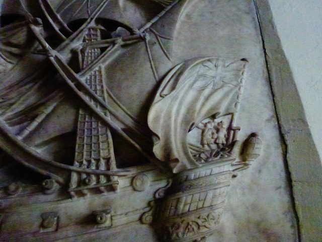 barking church, essex, on the deck of his ship, the captain can be seen sword held aloft, whilst two men blow trumpets in the stern. detail of the splendid tomb of captain john bennett, 1706