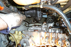 Unscrewing the oil cooler lines from a Mercedes-Benz OM617 turbodiesel engine