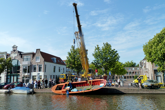 Crane pulling a boat out of the canal