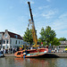 Crane pulling a boat out of the canal