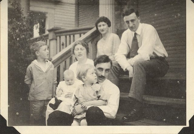 Dad (l), with his family: brother, Dick, in mother's lap, sister, Doris with her father. Aunt Kate and uncle Pete on top step. C. 1921