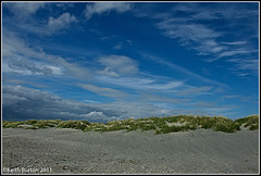 Cloudy blue skies over the sand dunes