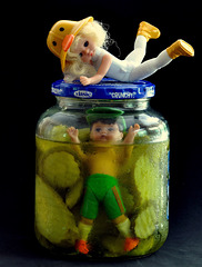 Little Susie Desperately Tries to Unscrew the Lid on the Pickle Jar Her Brother Joey is Trapped In