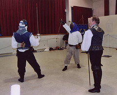 Alec and Targai Fencing with Llywellan Looking on at the Feast of St. Andrews, Nov. 2004