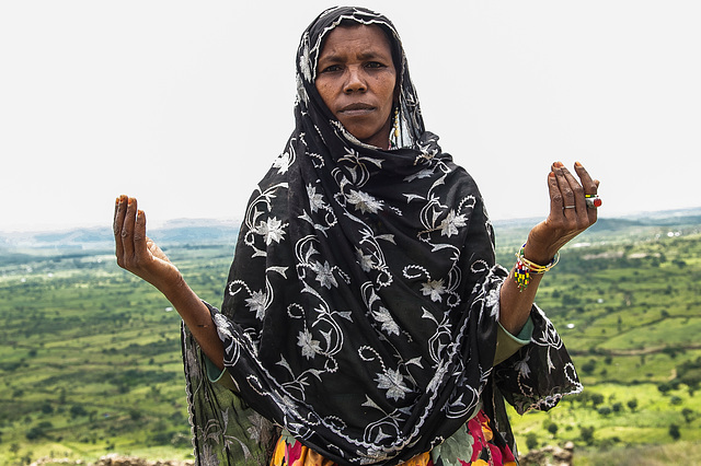 woman prying in kourumi village. Ethiopia