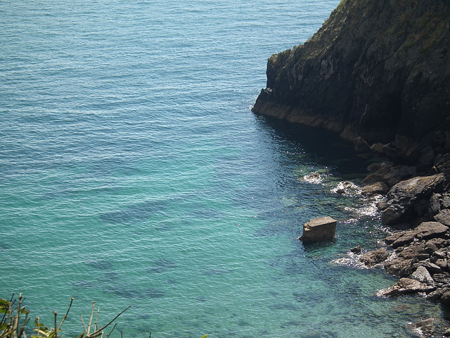 View down the cliff to the clear water