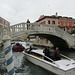 Tourists, getting a very expensive water taxi ride, snap their iPads at the lovely Ventian local on the bridge.