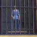 Manequin behind bars