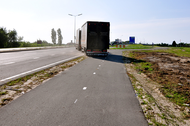 Truck on the cycle path after picking up cut grass