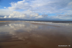Wet sand as mirror: Findhorn Beach at low tide.