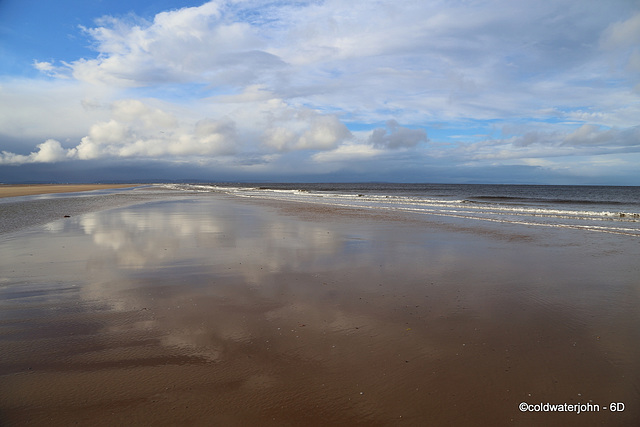 Wet sand as mirror: Findhorn Beach at low tide.