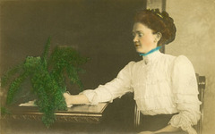 Blue-Collared Woman with Green Plant