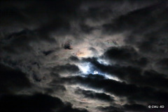 Stormy night with full moon trying to break through