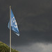 UN flag and stormy sky