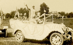 Lady Liberty and Her Family in a Decorated Parade Car