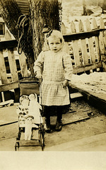 A Girl with a Baby Carriage Full of Dolls