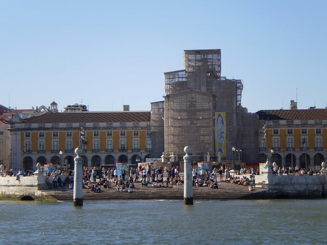 Lisbon - people gather on the riverside to watch sailing event.