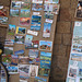 Board with postcards at the La Tanniére crepe stop. The post cards are "thank yous" from all over the world sent by past PBP riders after they returned home