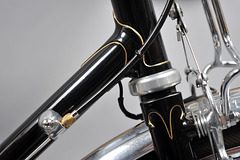 Thinned and tapered lower head lug, down tube gear cable stop for Ergopower shifter, and Vagner fork crown. Note: rack connection to brake pivots.