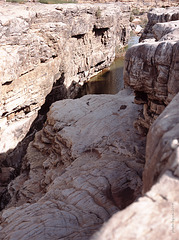 a small stream feeding on the rocks
