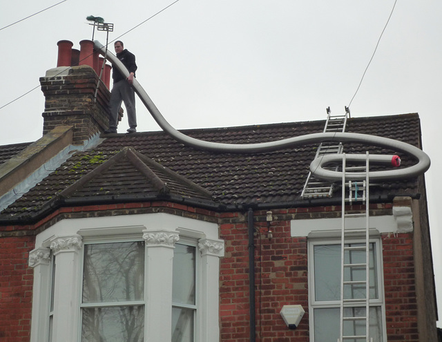 2. The end of the flue-liner is tied to the chimney brush
