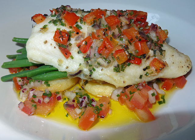 Hake with tomato and olive crust
