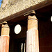 Columns alternating with suspended round bas-reliefs.