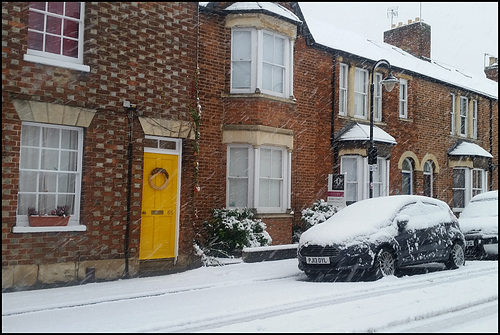 yellow door in the snow