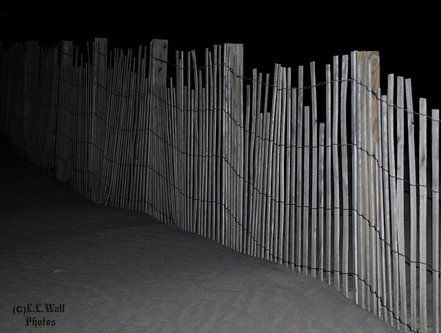 Ghostly Fence Atop the Sand