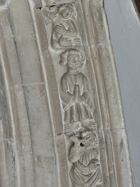 lawford church, essex , lively acrobats and musicians on window moulding around a c14 chancel window