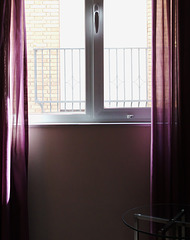Purple window drapes with table
