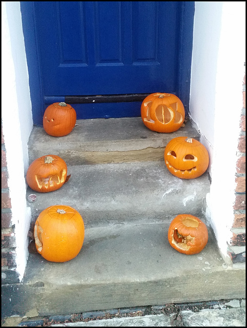 grinning pumpkins at the door