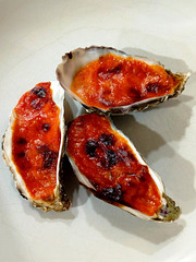 Oysters gratinated with mayonnaise, tomato paste and cheddar