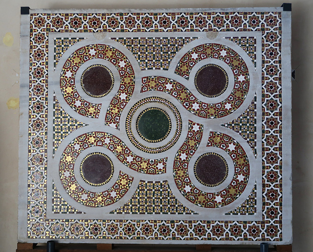 Piece of mosaic floor mounted on the wall