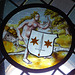 Nude Woman Supporting a Heraldic Shield Stained Glass Roundel in the Cloisters, October 2017