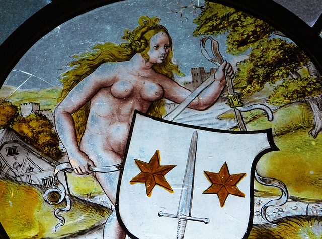 Detail of a Nude Woman Supporting a Heraldic Shield Stained Glass Roundel in the Cloisters, October 2017