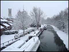 snow by a black canal