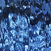 blue curtain behind rippled glass abstract