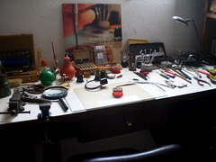 Table with equipment to restore and repair watches and clocks.