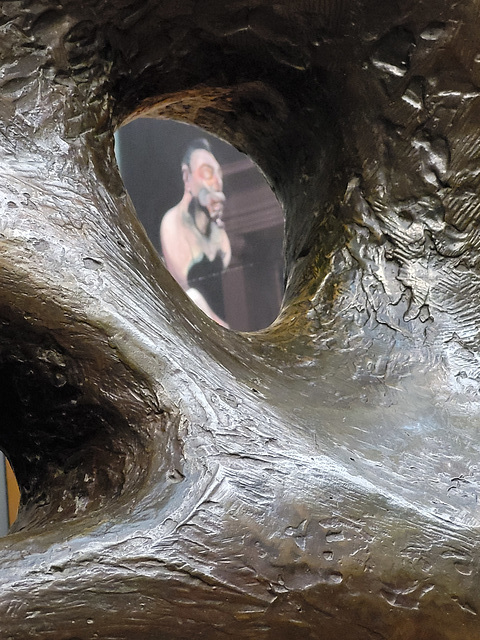 A Francis Bacon painting seen through a hole in a sculpture by Henry Moore