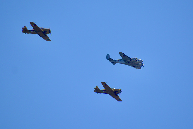 Beechcraft D18S flanked by two AT-16 Harvards