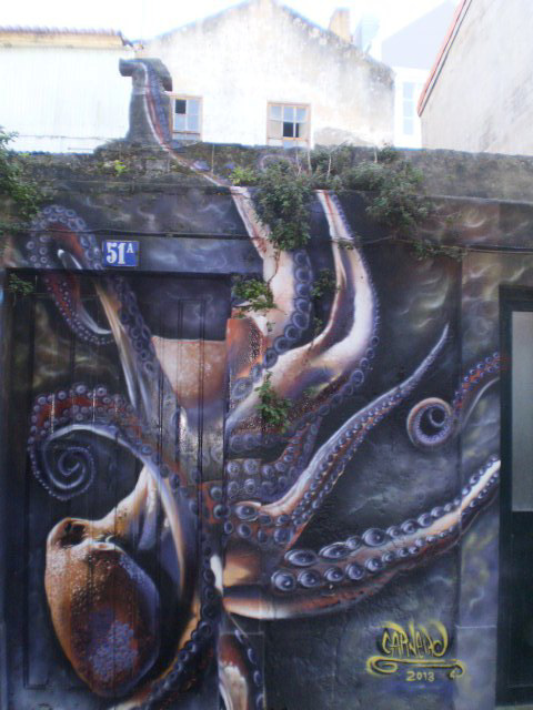 Octopus on ruins of house.