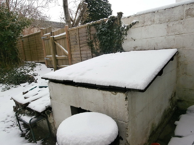 The coal bunker had at least 3" of snow on its top