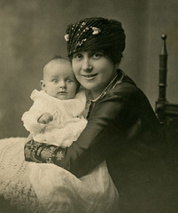 Smiling Mother with Wide-Eyed Baby