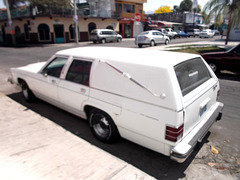 Blurry white hearse