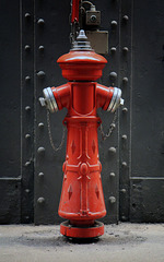 Little red mannequin or maybe a chess piece?