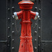 Little red mannequin or maybe a chess piece?