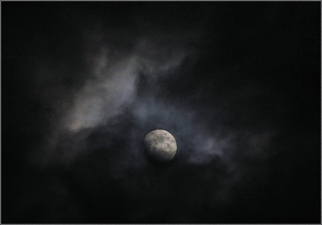Clouds scudding past the waxing moon last night