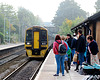 Passengers Waiting for a Train on a Misty Day
