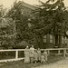 Women and Kids in Front of a House